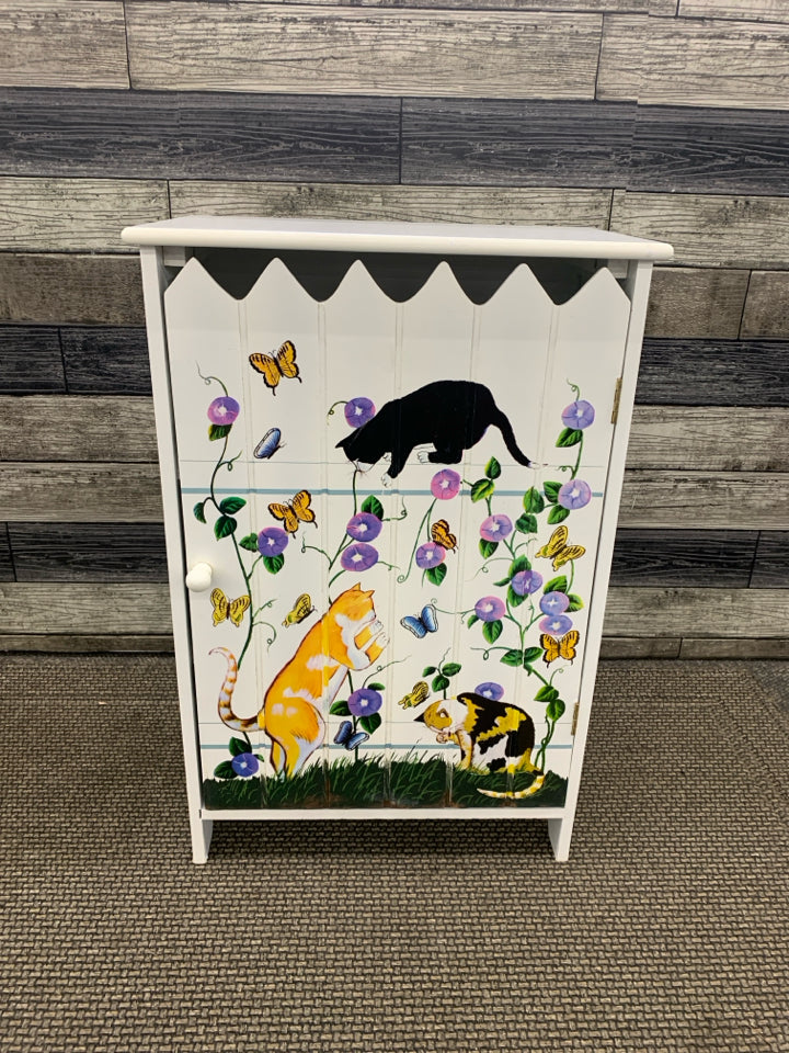 SMALL WHITE PAINTED CABINET W CATS AND FLORAL-3 SHELVES.