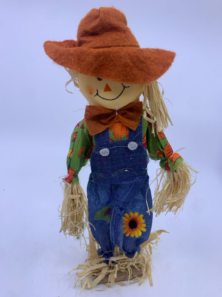 SCARECROW W/ WOOD STAND BLUE STRIPPED OVERALLS.