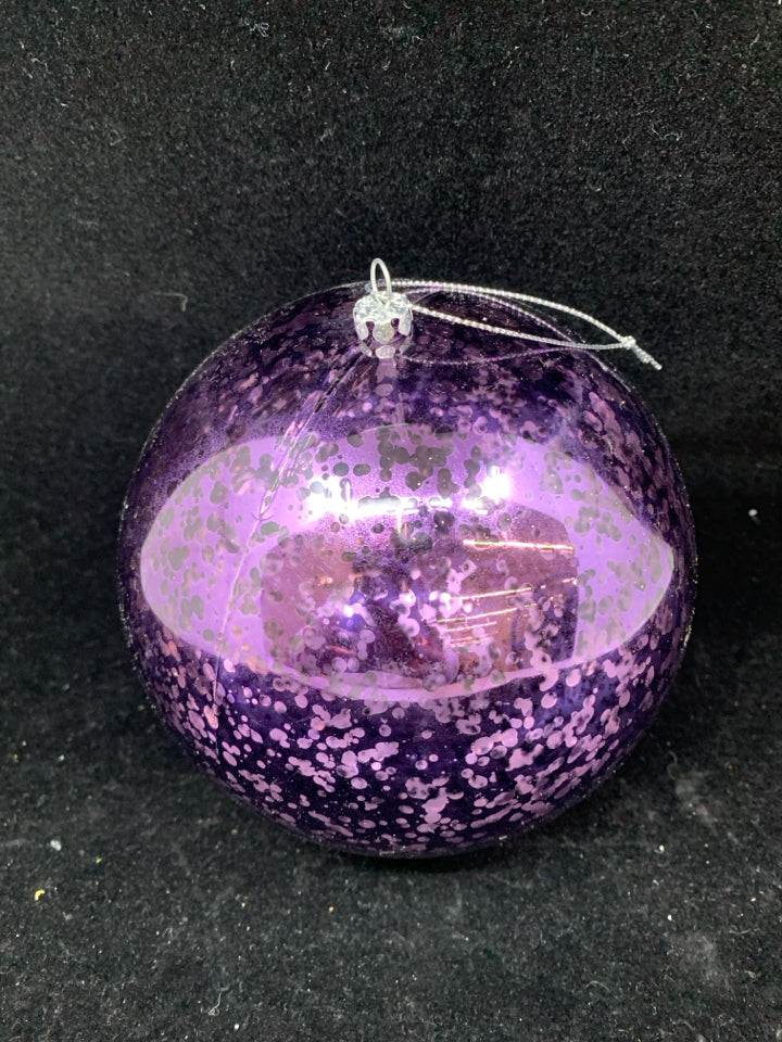 LARGE PLASTIC PURPLE ORNAMENT.