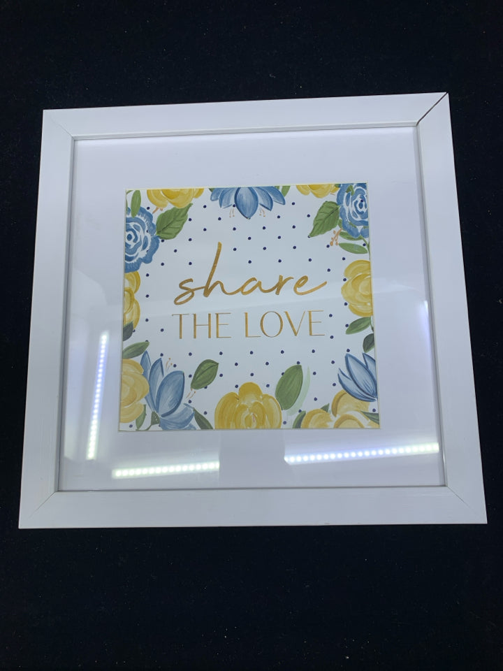 SHARE THE LOVE BLUE AND YELLOW FLORAL IN WHITE FRAME WALL HANGING.