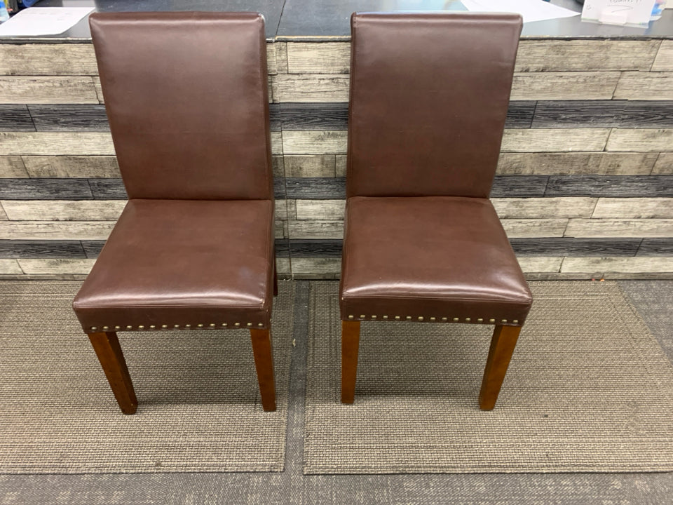 2 BROWN FAUX LEATHER CHAIRS W/ STUDDED EDGE.