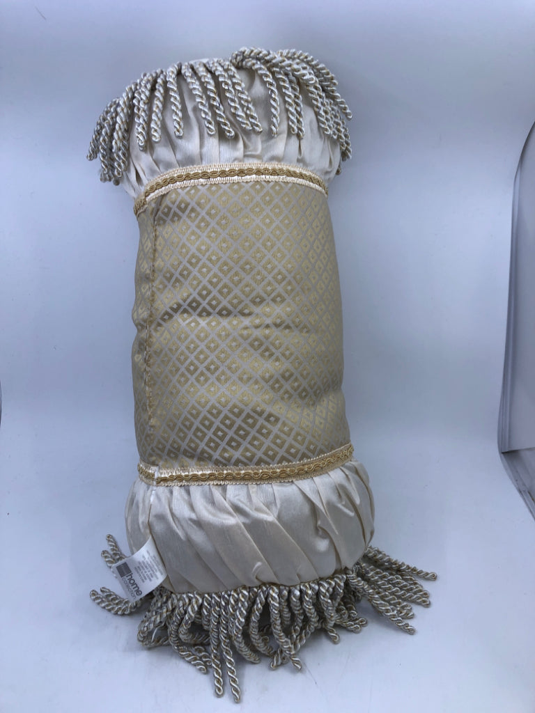 CREAM CYLINDER PILLOW WITH TASSELS.
