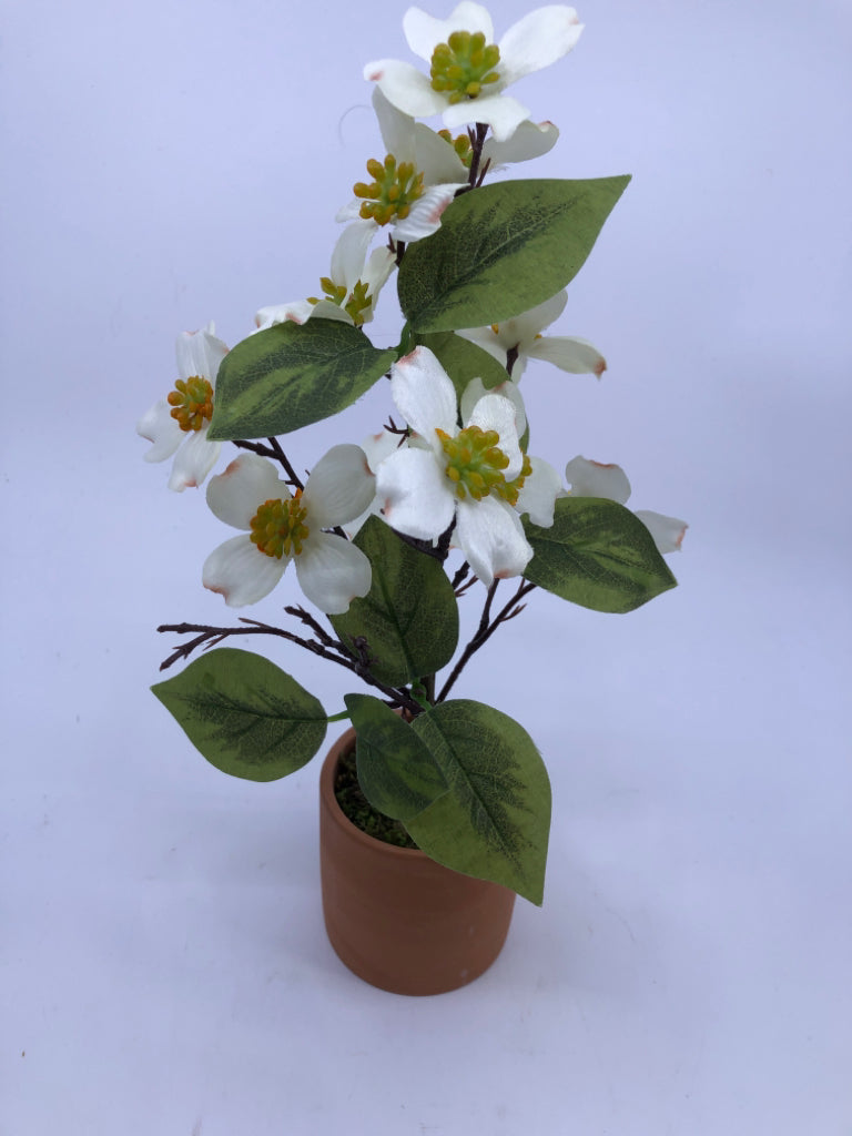 FAUX WHITE FLORAL IN TERRA COTTA PLANTER.