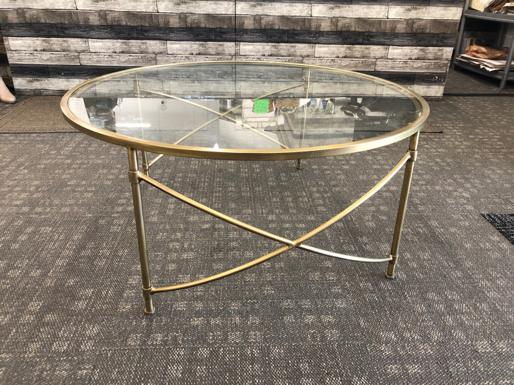 ROUND GLASS TOP COFFEE TABLE.