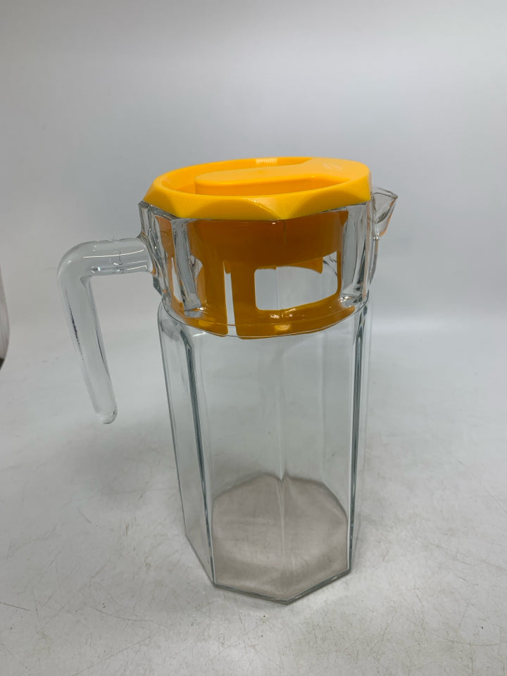 GLASS OCTAGON SHAPE SHAPE PITCHER W/ YELLOW LID.