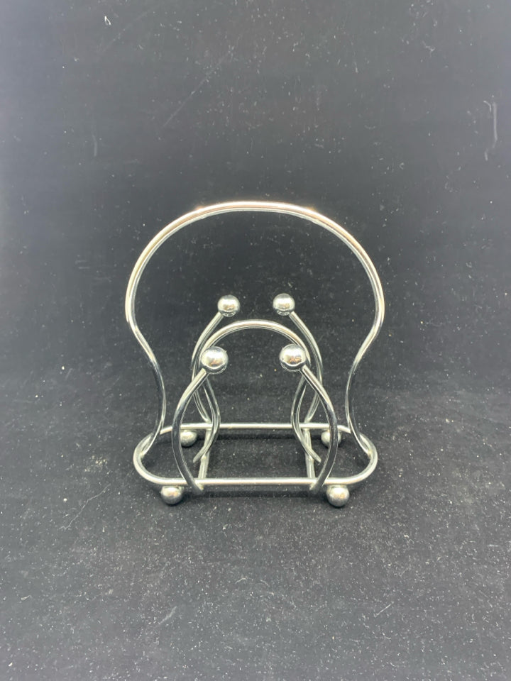 SILVER METAL NAPKIN HOLDER.