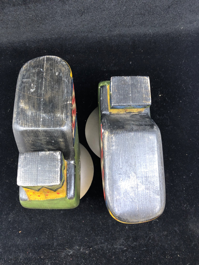 2 HEAVY WOOD SHOES W/ PAINTED DETAIL PILLAR CANDLE HOLDERS.