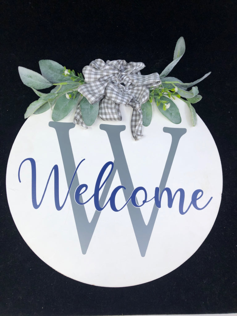 WHITE W GREENS ROUND WELCOME SIGN.