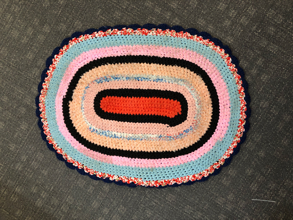 OVAL MULTI-COLOR WOVEN RUG.