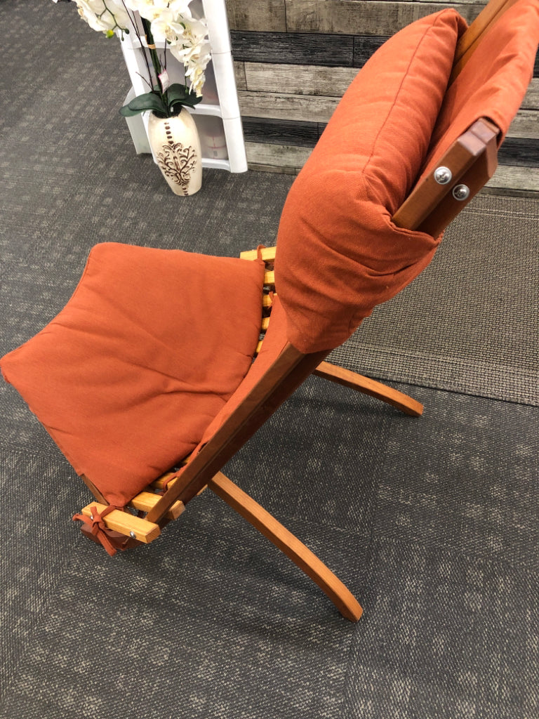 ARTISAN MADE TEAK WOOD FOLDABLE CHAIR W/ BURNT ORANGE CUSHIONS.