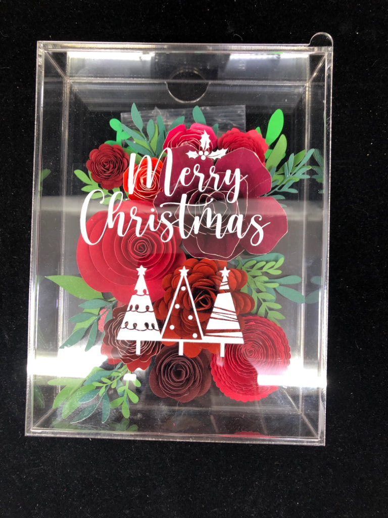 CLEAR PLASTIC SHADOW W/ ROLLING PAPER FLOWERS MERRY CHRISTMAS.