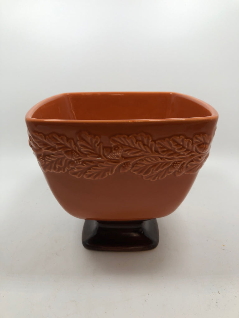 ORANGE PEDESTAL BOWL W/EMBOSSED ACORNS.