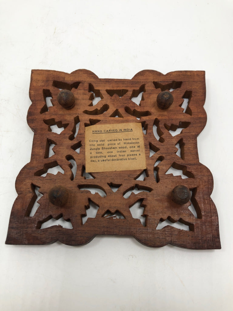 HAND-CARVED WOODEN TRIVET W/FLOWER CENTER.