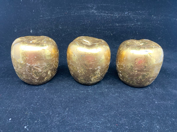 3 GOLD APPLE SHAPED CANDLES.