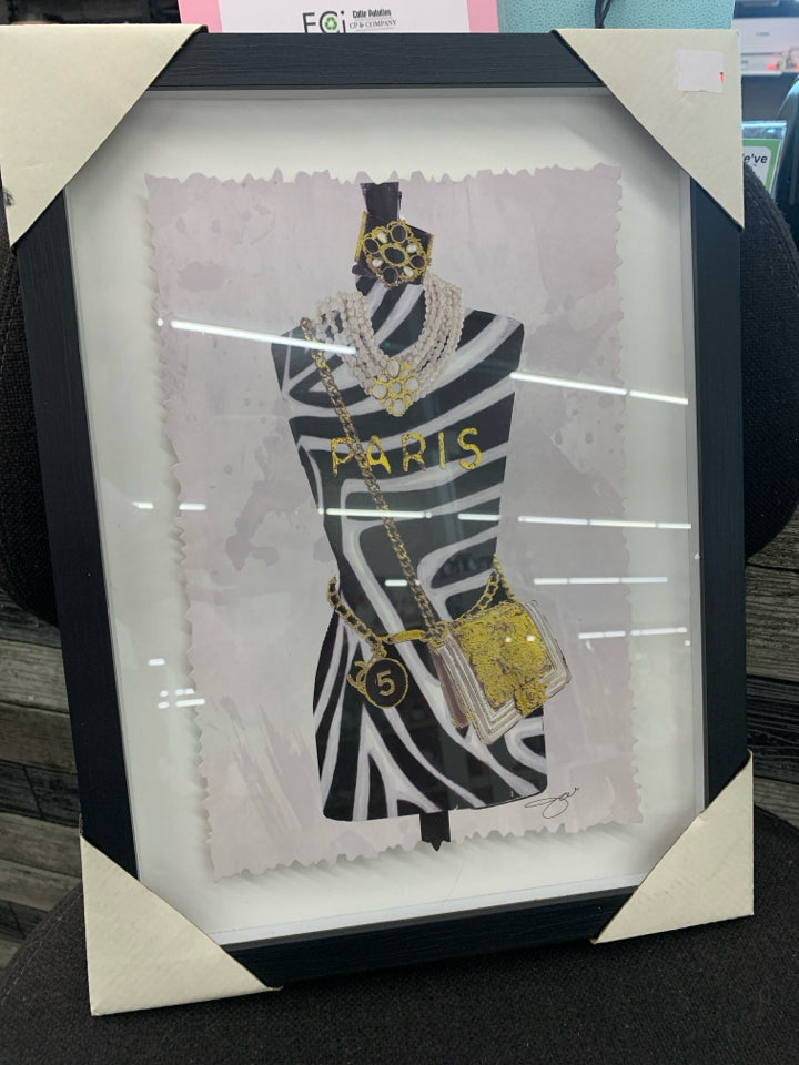ANIMAL PRINT MANNEQUIN FORM IN BLACK FRAME.
