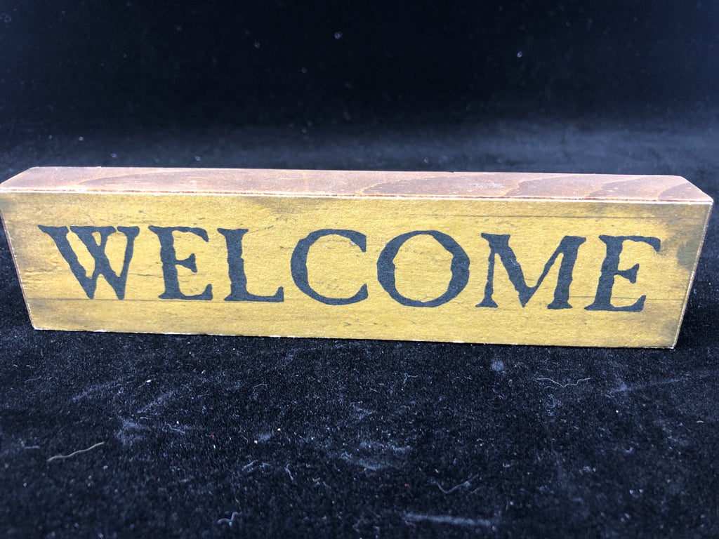 PRIMITIVE "WELCOME" BLOCK SIGN.