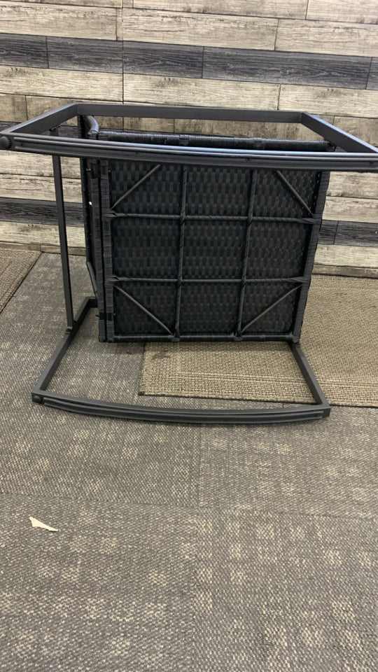 BLACK WICKER OUTDOOR ROCKING CHAIR.