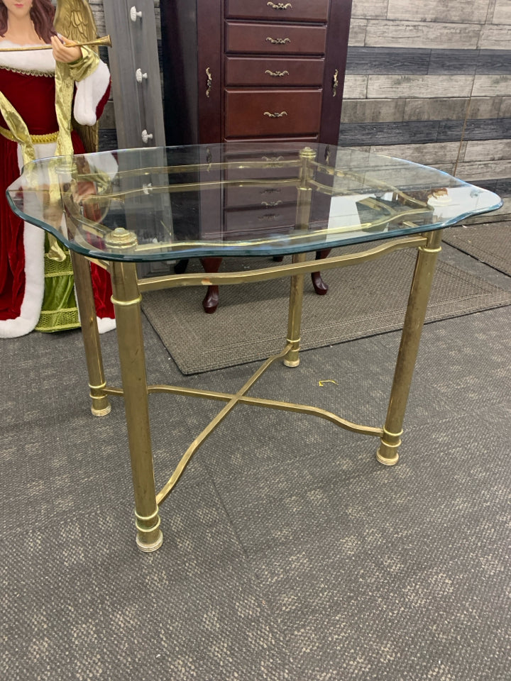 GOLD TABLE W/GLASS TOP AND X BASE.