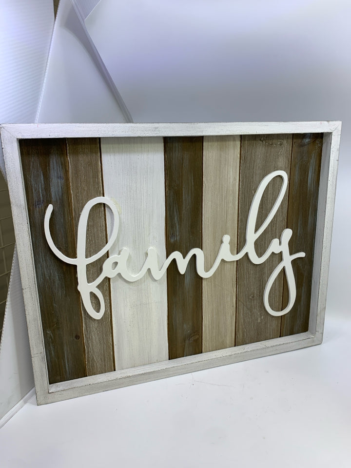 "FAMILY" ON WOOD SLATS IN WHITE FRAME.