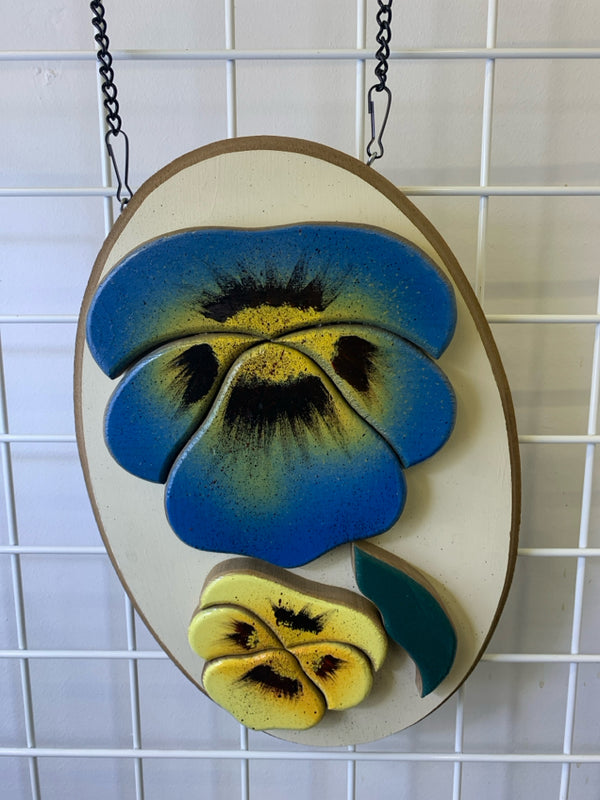 OVAL WOODEN BLUE AND YELLOW FLORAL WALL HANGING.
