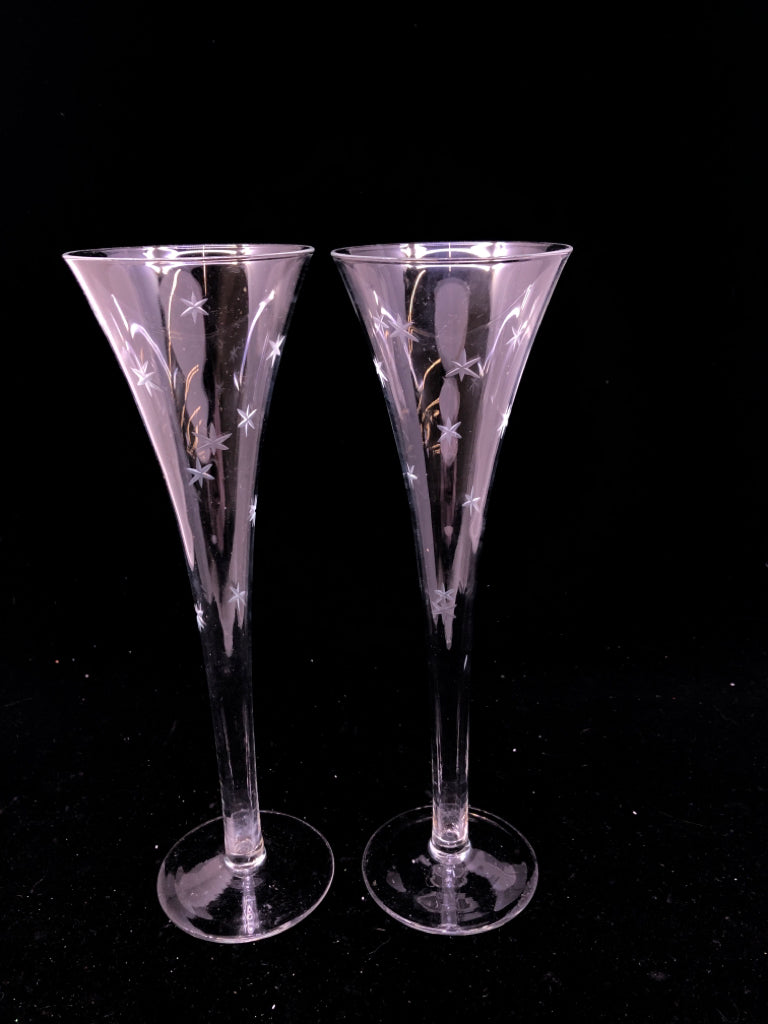 2 GLASS CHAMPAGNE FLUTES W/ ETCHED STARS.