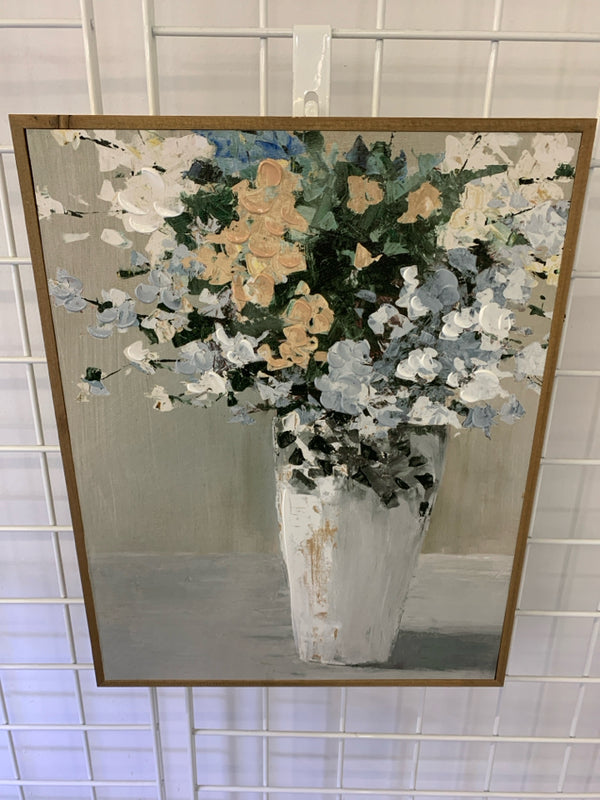 TEXTURED WHITE, TAN, BLUE, GREEN FLOWERS IN TALL WHITE VASE IN BROWN FRAME.