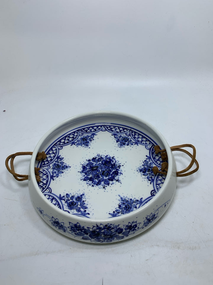 WHITE DEEP CERAMIC TRAY W/ BLUE FLORAL DESIGN LEATHER HANDLES.