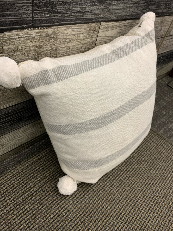 GREY STRIPED PILLOW W POMPOMS.