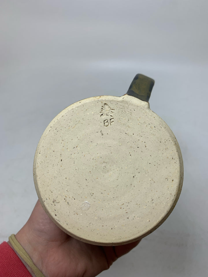 DARK COLORED POTTERY MUG.