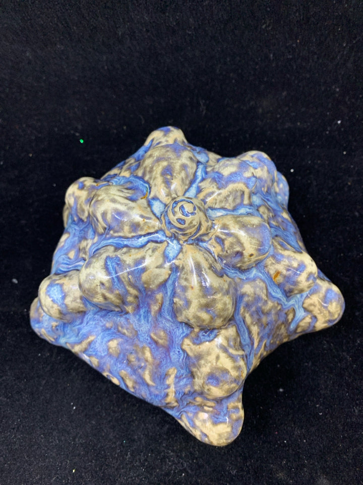 CERAMIC ART WITH TEXTURED BLUE AND BROWN GLAZE.