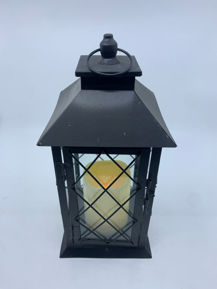 FLAMELESS CANDLE IN METAL LANTERN.