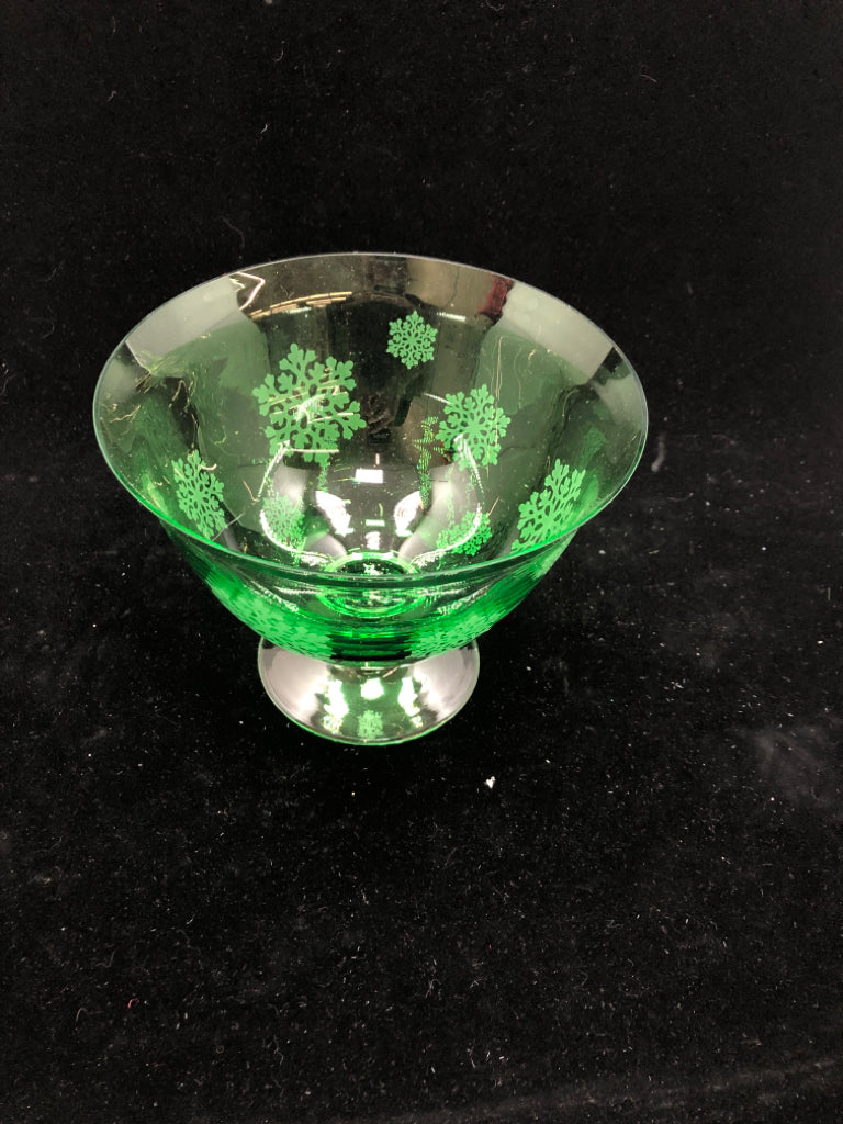 GREEN GLASS FOOTED BOWL W/EMBOSSED SNOWFLAKES.