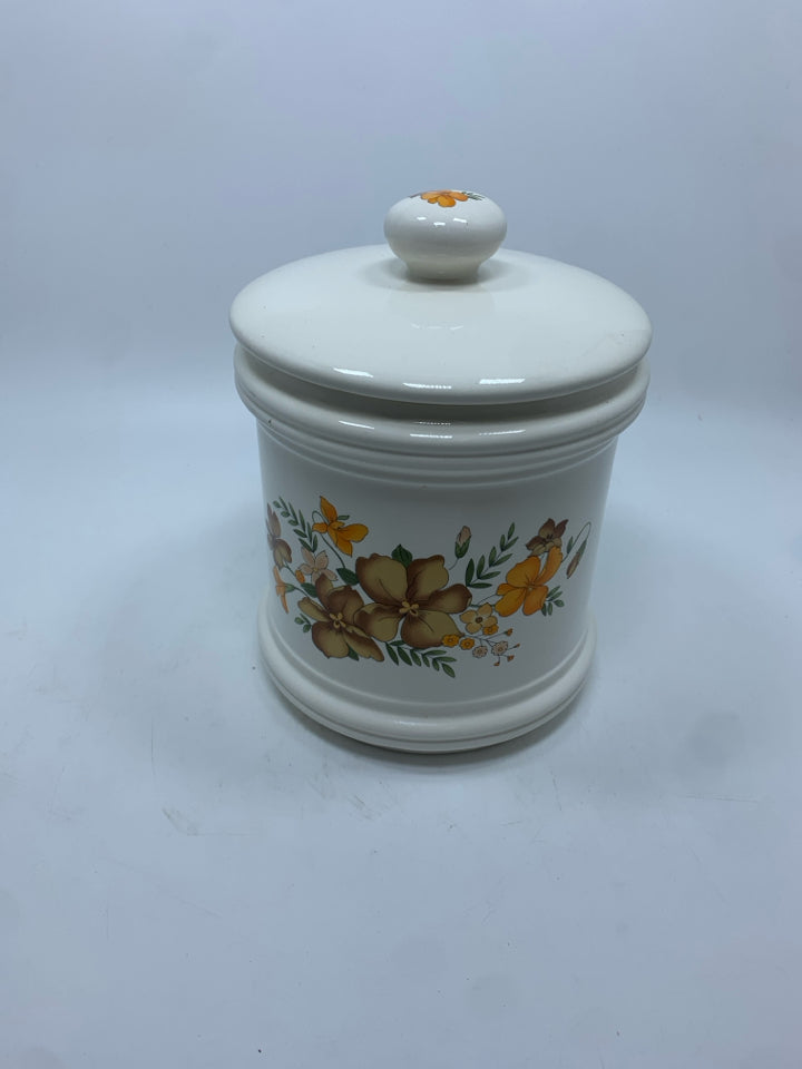 WHITE CERAMIC CANISTER W/BROWN AND ORANGE FLOWERS.