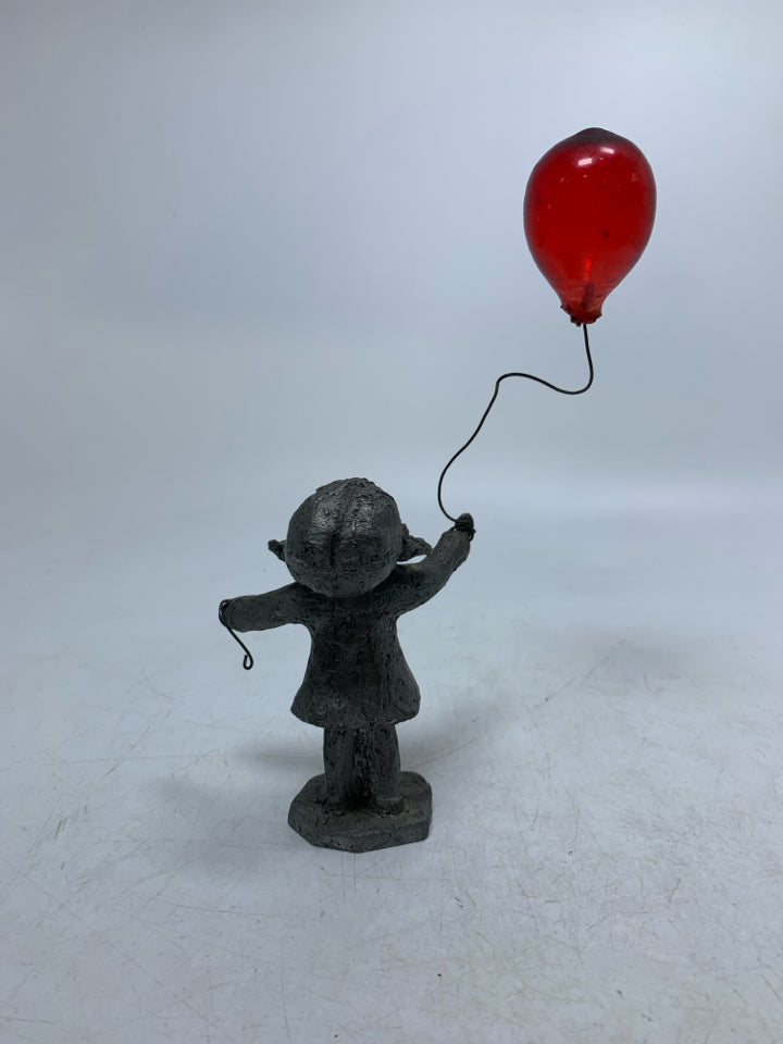 GIRL HOLDING BALLOON FIGURINE.