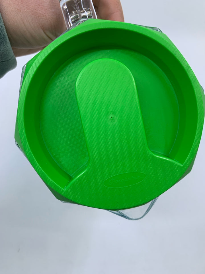 CLEAR GLASS PITCHER W/ GREEN PLASTIC TOP.