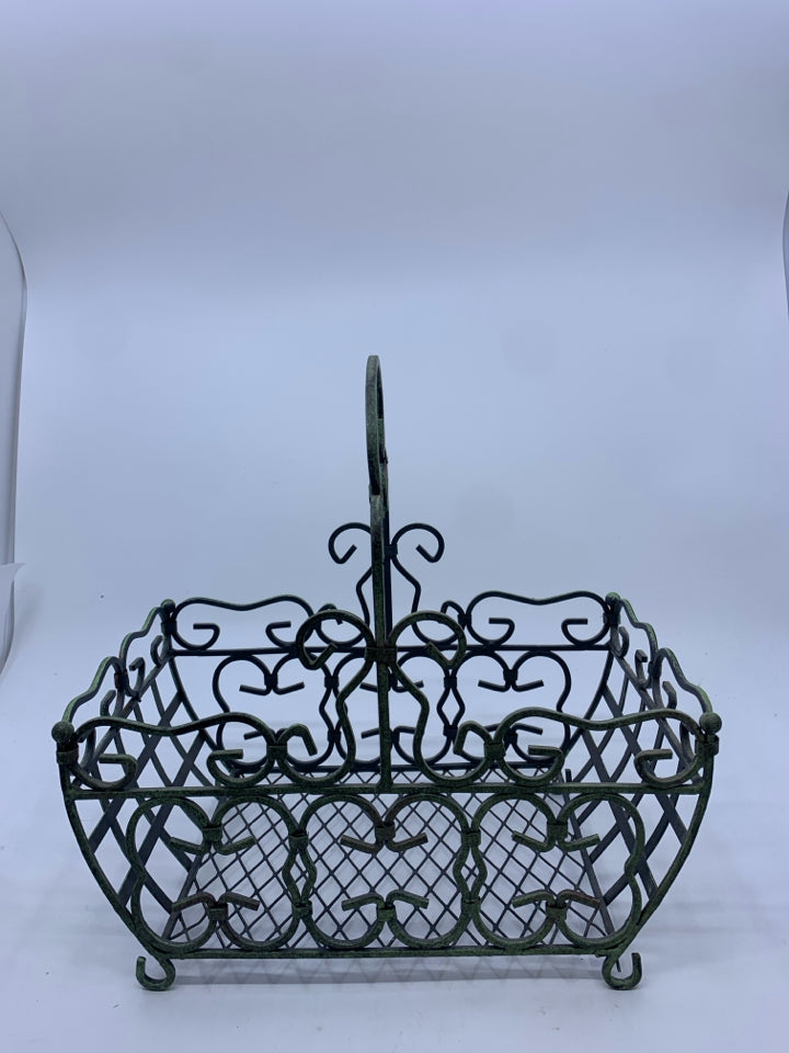 DISTRESSED FOOTED METAL BASKET W/ GREEN TINT SCROLL DESIGN.