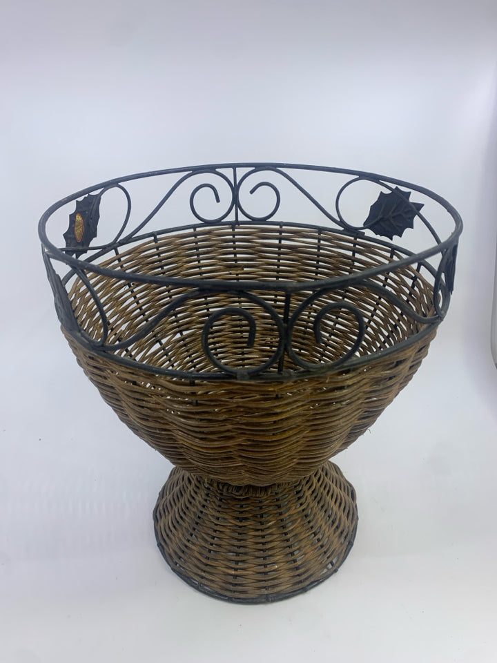 METAL SCROLL AND WICKER PLANTER BASKET W/LEAF DETAILS.