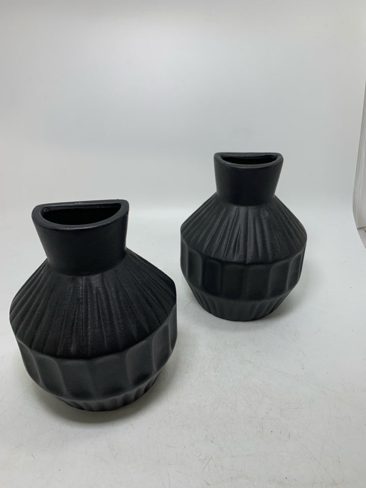 2 BLACK CERAMIC ONE FLAT SIDE VASES.