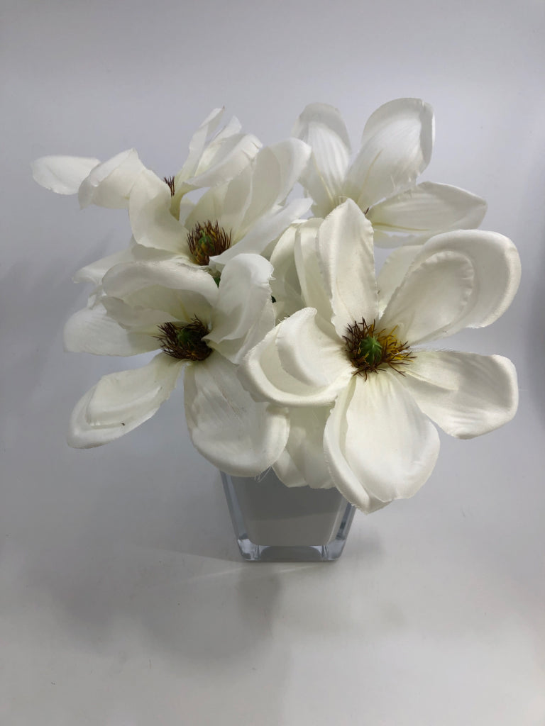 FAUX MAGNOLIA FLOWERS IN WHITE GLASS VASE.