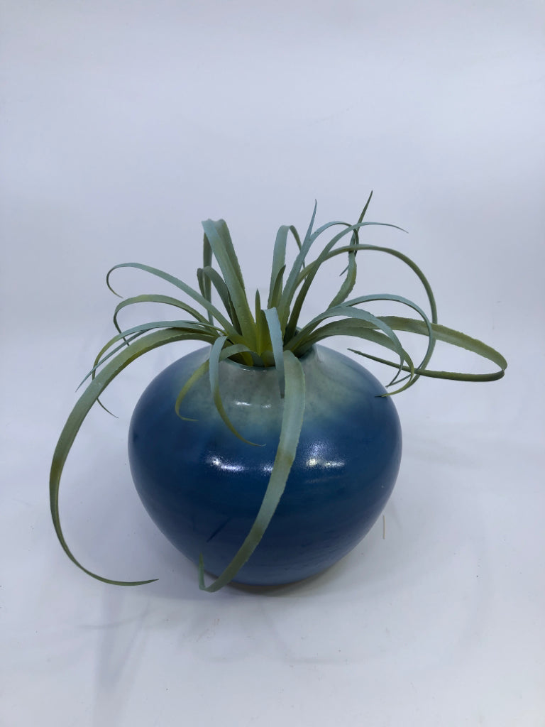 BLUE CERAMIC VASE W/ LIGHT COLORED NECK FAUX LEAVES.