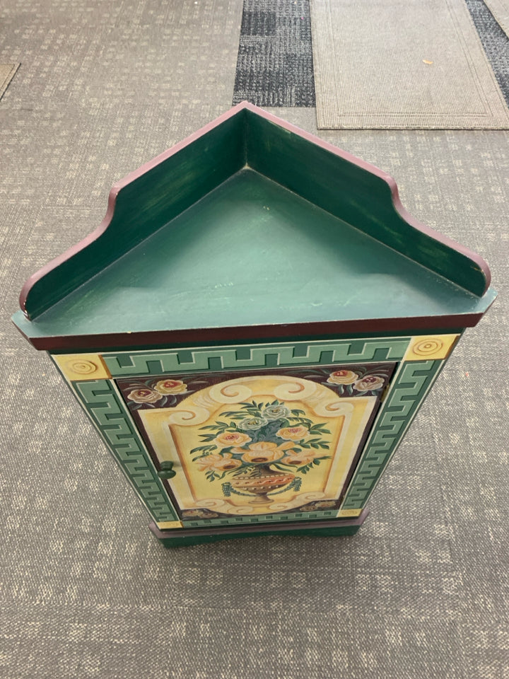 SMALL CORNER CABINET DARK GREEN/MAROON W/ VASE YELLOW ROSES.