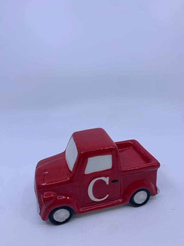 SMALL CERAMIC RED TRUCK W/ "C" ON IT.