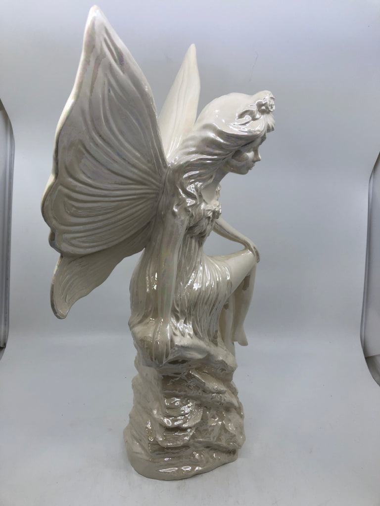 LARGE IRIDESCENT FAIRY SITTING ON A ROCK CERAMIC.