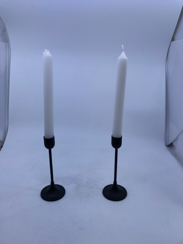 2 BLACK TAPER CANDLE HOLDER WITH WHITE CANDLES.
