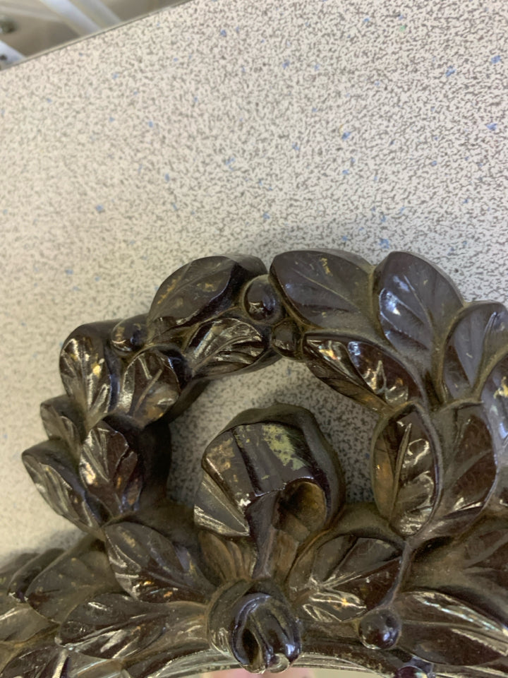 VTG OVAL MIRROR W/BROWN BORDER & FLORAL DECOR ON TOP WALL HANGING.