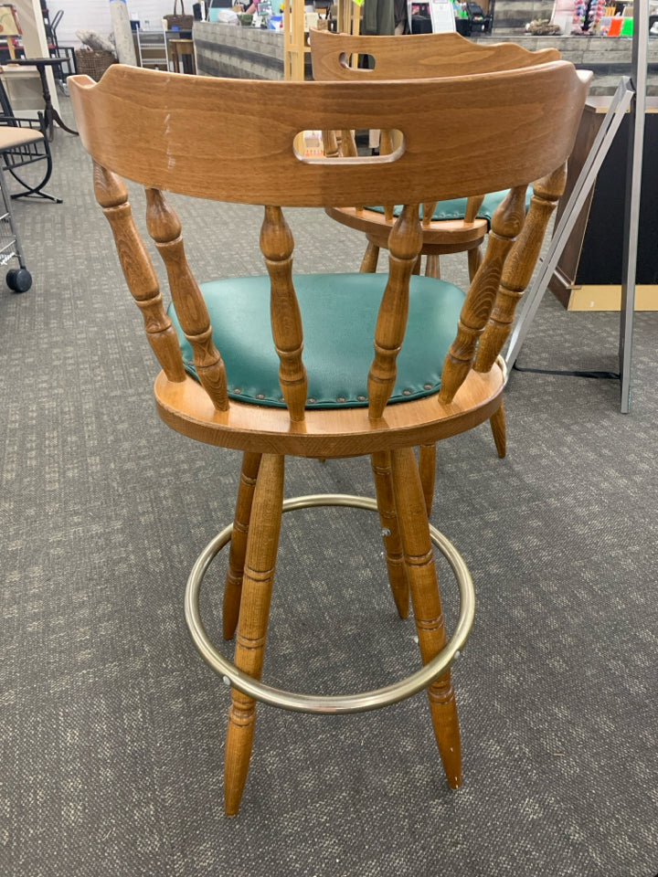2 WOOD BAR STOOL W/GREEN UPHOLSTERED CUSHION & METAL FOOT REST.