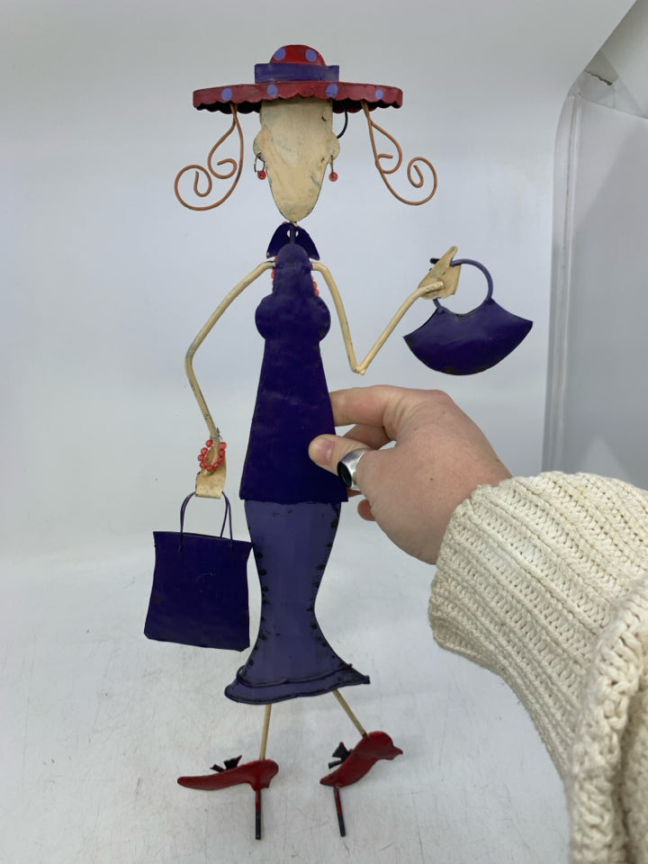 METAL WOMAN IN PURPLE DRESS W/ GLASSES & RED SHOES.