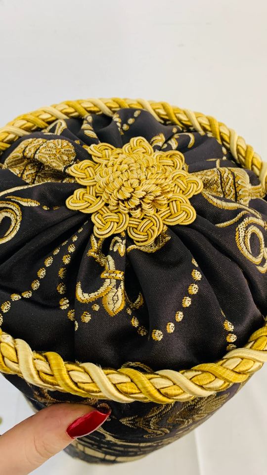 BLACK AND GOLD CYLINDER PILLOW.