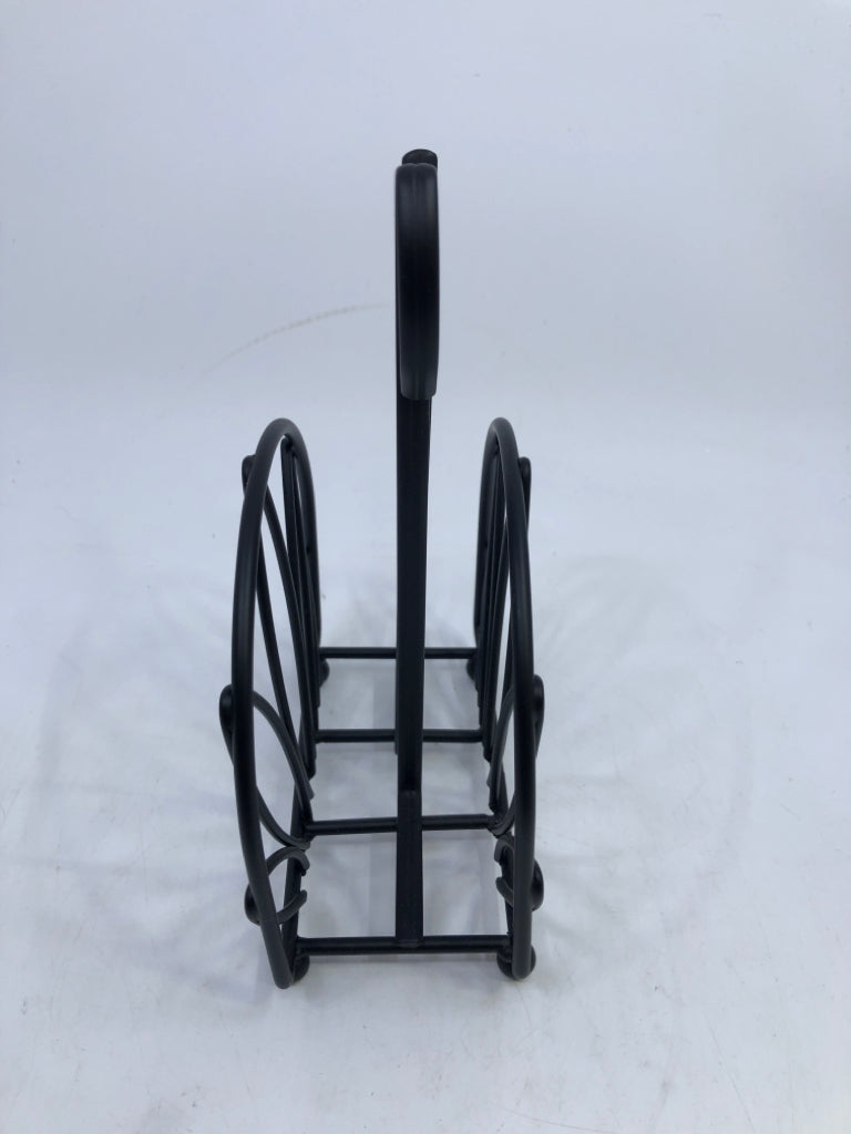 BLACK METAL CUTOUT NAPKIN HOLDER.