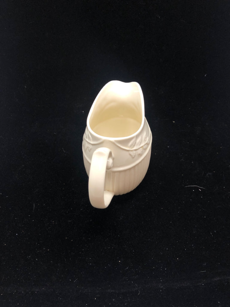 IVORY PITCHER EMBOSSED VINE LEAF PATTERN.